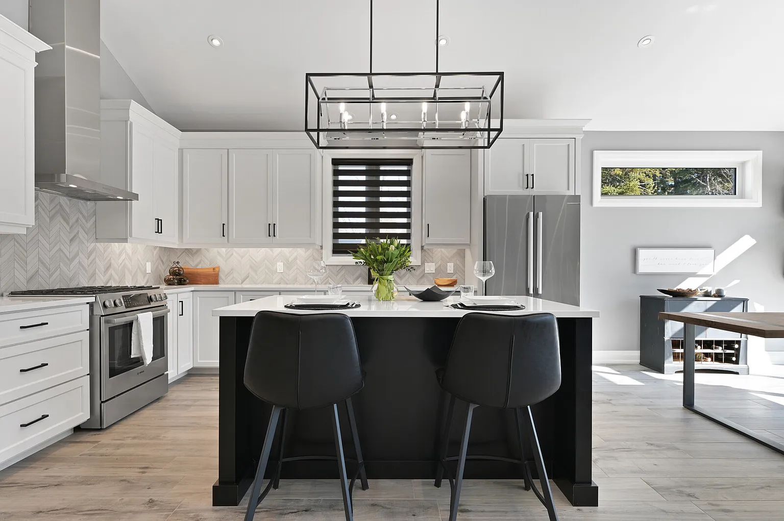 Custom kitchen with black island and chevron tile backsplash